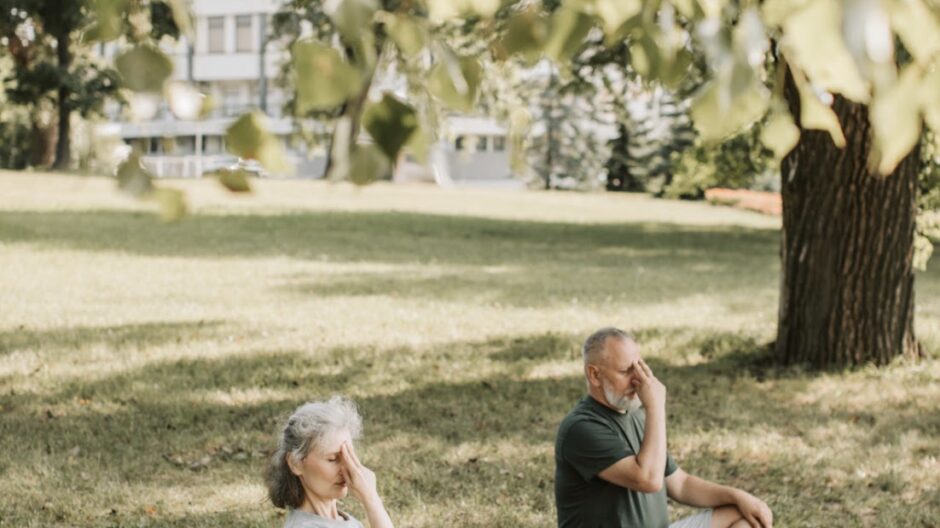 Man and woman doing yoga in nature.